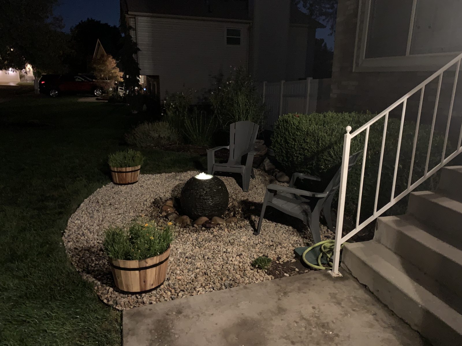 Lit sphere fountain in a front-yard sitting area