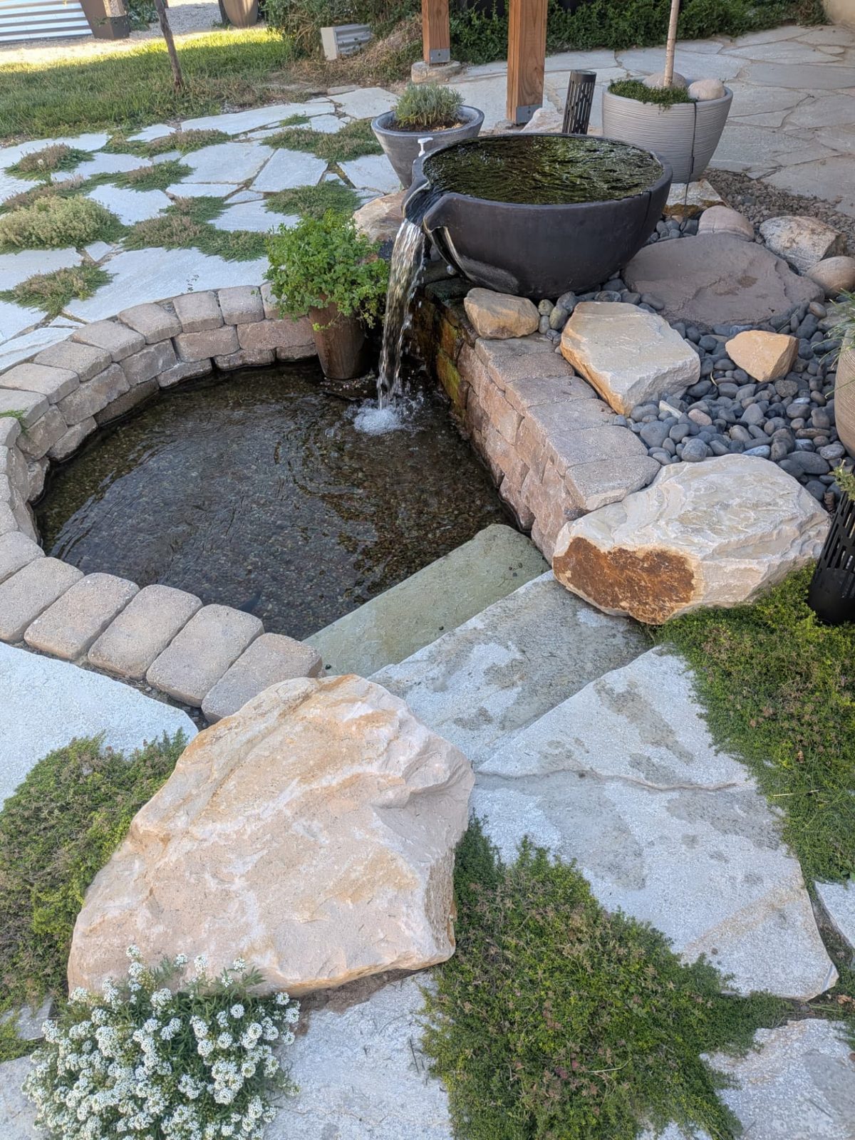 Spillway bowl and stone basin on a flagstone patio