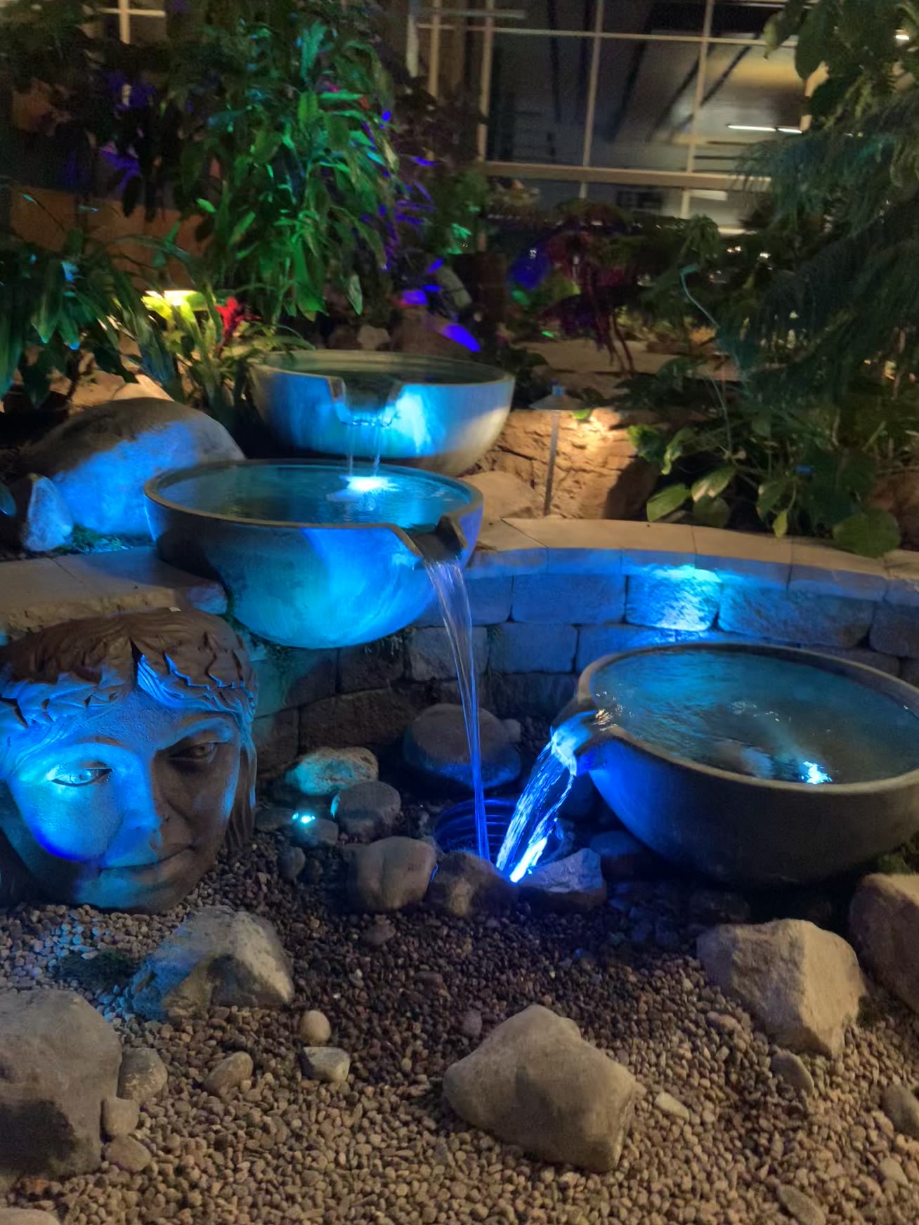 Blue-lit fountain bowls